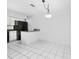 Eat-in kitchen features tiled floors, a modern light fixture, and black appliances set against light gray walls at 135 Heron Bay Cir, Lake Mary, FL 32746