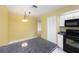 A well lit kitchen with an island and black countertops, and white cabinets and appliances at 135 Heron Bay Cir, Lake Mary, FL 32746