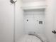 Practical laundry room with shelving, tile floors, and white walls, providing a clean and functional space at 135 Heron Bay Cir, Lake Mary, FL 32746