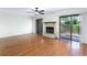 Bright living room featuring a fireplace, wood floors, ceiling fan, and sliding glass doors to the outside at 135 Heron Bay Cir, Lake Mary, FL 32746