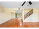 Bright living space with hardwood floors, ceiling fan, and staircase leading upstairs at 135 Heron Bay Cir, Lake Mary, FL 32746