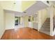 Inviting living room with hardwood floors, staircase, and access to entryway and kitchen at 135 Heron Bay Cir, Lake Mary, FL 32746