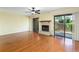 Spacious living room featuring a fireplace, sliding glass doors, and hardwood floors at 135 Heron Bay Cir, Lake Mary, FL 32746