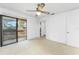 Spacious main bedroom featuring balcony access, ceiling fan, and ensuite bathroom, offering comfort and convenience at 135 Heron Bay Cir, Lake Mary, FL 32746