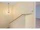 Bright staircase featuring neutral walls, elegant lighting, and light-colored carpeting for a welcoming transition at 135 Heron Bay Cir, Lake Mary, FL 32746