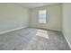 Cozy carpeted bedroom with a window offering natural light at 144 Angelas Ave, Haines City, FL 33844