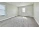Spacious bedroom features carpeted floors and large windows for natural light at 144 Angelas Ave, Haines City, FL 33844