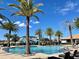A sparkling community pool surrounded by lush palm trees offers a refreshing oasis for residents to enjoy at 144 Angelas Ave, Haines City, FL 33844