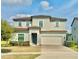 Two-story home featuring neutral paint, attached two-car garage, well-maintained landscaping and a brick driveway at 144 Angelas Ave, Haines City, FL 33844