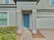 Charming covered front entry with blue door and neatly trimmed bushes at 144 Angelas Ave, Haines City, FL 33844
