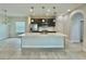 Kitchen with tile floors, stainless steel appliances, pendant lights and an island sink at 144 Angelas Ave, Haines City, FL 33844