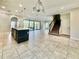 Open living area featuring tile floors, an island sink, a staircase and a patio with a view at 144 Angelas Ave, Haines City, FL 33844