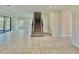 Spacious living room features tile flooring, staircase, and sliding glass doors to the backyard at 144 Angelas Ave, Haines City, FL 33844