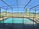 Screened-in pool with lake view, perfect for relaxing and entertaining at 144 Angelas Ave, Haines City, FL 33844