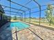 Screened-in pool with lake view, perfect for relaxing and entertaining at 144 Angelas Ave, Haines City, FL 33844