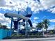 A blue and white waterslide stands tall against a vibrant sky, promising fun in the community's recreational area at 144 Angelas Ave, Haines City, FL 33844
