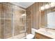Bathroom featuring a glass shower, toilet, mirror, vanity, and striped wallpaper at 1448 Conway Isle Cir, Belle Isle, FL 32809