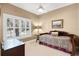 Cozy bedroom with a patterned daybed, side table, and large window offering natural light at 1448 Conway Isle Cir, Belle Isle, FL 32809