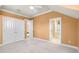 Bedroom features neutral color, carpet, closet with double doors, and access to the ensuite bathroom at 1448 Conway Isle Cir, Belle Isle, FL 32809