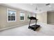 Large, light-filled bonus room with multiple windows and a ceiling fan, ideal for a home gym or recreation area at 1448 Conway Isle Cir, Belle Isle, FL 32809