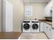 Functional laundry room with washer, dryer, and ample counter space, perfect for convenience at 1448 Conway Isle Cir, Belle Isle, FL 32809