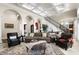 Open living room featuring hardwood floors, fireplace, archways, coffered ceilings, and a staircase at 1448 Conway Isle Cir, Belle Isle, FL 32809