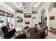 Bright living room showcasing a fireplace, built-ins, coffered ceilings and backyard views at 1448 Conway Isle Cir, Belle Isle, FL 32809