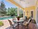 Covered patio offers outdoor dining near the pool, ideal for entertaining at 1448 Conway Isle Cir, Belle Isle, FL 32809