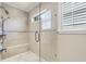 Modern shower featuring a glass enclosure, tiled walls, a built-in bench, and a rainfall shower head at 1448 Conway Isle Cir, Belle Isle, FL 32809