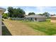 Large fenced backyard with green grass and ample space for outdoor activities at 15 Sawfish Ln, Kissimmee, FL 34759