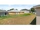 A large fenced in yard with a partially dried lawn is ready for your personal touch at 15 Sawfish Ln, Kissimmee, FL 34759