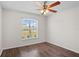 This bedroom features a ceiling fan, window, and updated flooring at 15 Sawfish Ln, Kissimmee, FL 34759