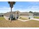 Well-maintained single-story home with a two-car garage, neutral color scheme, and tidy front yard at 15 Sawfish Ln, Kissimmee, FL 34759