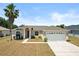 Charming single-story home featuring a two-car garage, manicured lawn, and a welcoming front entrance at 15 Sawfish Ln, Kissimmee, FL 34759