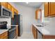 Efficient kitchen featuring stainless steel appliances, granite countertops, and ample cabinet space at 15 Sawfish Ln, Kissimmee, FL 34759