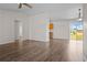 Bright living space with wood-look flooring, an open layout, and access to a modern kitchen at 15 Sawfish Ln, Kissimmee, FL 34759