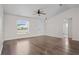 Neutral living space with laminate flooring, a ceiling fan, and large windows for ample natural light at 15 Sawfish Ln, Kissimmee, FL 34759