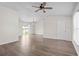 Open-concept living space featuring laminate flooring, a ceiling fan, and sliding glass doors leading to the backyard at 15 Sawfish Ln, Kissimmee, FL 34759