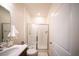 Bright bathroom featuring a glass-enclosed shower and modern vanity with storage at 16301 Sanctuary Reserve Loop, Clermont, FL 34714