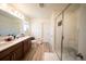 Bathroom featuring a double vanity, shower, and tile flooring at 16301 Sanctuary Reserve Loop, Clermont, FL 34714