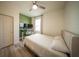 Cozy bedroom featuring a ceiling fan, wood floors, and a dedicated computer space at 16301 Sanctuary Reserve Loop, Clermont, FL 34714