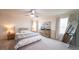Bedroom with a ceiling fan, neutral-toned walls, and a large window at 16301 Sanctuary Reserve Loop, Clermont, FL 34714