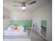 Bright bedroom with decorative wall art, a modern ceiling fan, and a white framed bed at 16301 Sanctuary Reserve Loop, Clermont, FL 34714