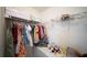 Closet featuring hanging clothes, shelves with boxes, and a vanity table at 16301 Sanctuary Reserve Loop, Clermont, FL 34714