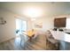 Bright dining area adjacent to a modern kitchen with a breakfast bar and access to patio at 16301 Sanctuary Reserve Loop, Clermont, FL 34714