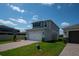 Two-story home boasting a two-car garage, pristine landscaping, and a well-manicured lawn at 16301 Sanctuary Reserve Loop, Clermont, FL 34714