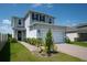 Charming two-story home featuring a two-car garage, well-maintained lawn, and inviting curb appeal at 16301 Sanctuary Reserve Loop, Clermont, FL 34714