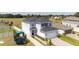 Two-story home with attached garage and trampoline, nestled in a green backyard with white fence at 16301 Sanctuary Reserve Loop, Clermont, FL 34714