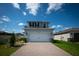 Two-car garage with a paver driveway and manicured landscaping at 16301 Sanctuary Reserve Loop, Clermont, FL 34714