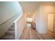 Bright hallway with stairs and wood floors leading to a living area bathed in natural light at 16301 Sanctuary Reserve Loop, Clermont, FL 34714